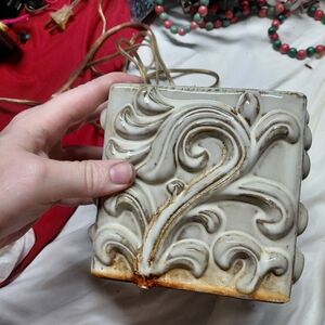 Ornate Cream Ceramic Accent Tile with Distressed Brown Patina